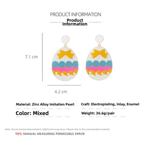Detail of colorful Easter egg earrings with yellow bow and pearl accent details