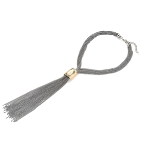 Multilayer chain tassel necklace with silver strands and golden tube accent on white backdrop