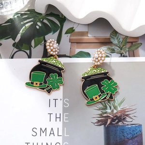 Detail of St. Patrick's Day earrings with green enamel clover and pearl accents