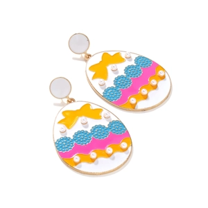 Close-up of Easter egg earrings with colorful enamel bow and pearl inlay detail