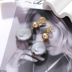 Baroque irregular pearl drop earrings with hollow golden cages in a vintage style