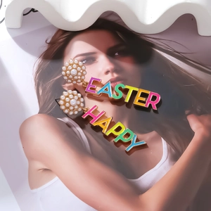 Detail view of colorful Easter enamel letter earrings with pearls on a magazine page