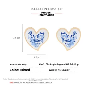 Detail view of heart-shaped blue porcelain earrings with measurements 3.5cm by 3.7cm