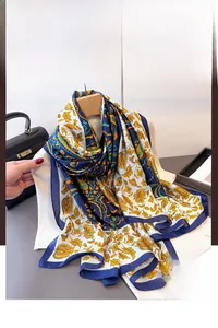 Detail of navy and gold vintage paisley silk scarf styled on a cozy sweater