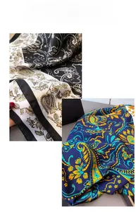 Detailed view of vintage paisley and floral patterns on silky satin scarves with elegant sheen