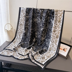Classic paisley print faux silk scarf displayed on a stand with elegant vintage style