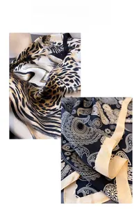 Close-up of leopard animal print and blue paisley patterns on smooth satin silk scarves