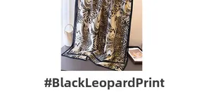 Detail of leopard and zebra print silk scarf draped by a handbag and fashion magazine