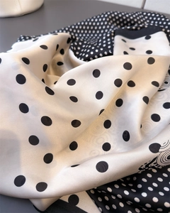 Detailed view of silk leopard print scarf showing soft texture and smooth draped fabric