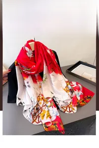 Close-up of red and white floral faux silk scarf showing soft fabric texture and elegant print