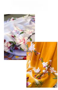 Detail view of floral print faux silk scarf with elegant white magnolia patterns