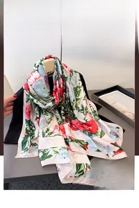 Close-up of lightweight floral silk scarf with vibrant red and blue botanical print