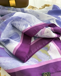 Detail of purple gradient silk scarf fabric texture with luxury satin finish and brand label