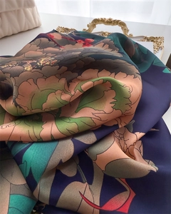 Detail of silk satin scarf with floral peony patterns on vintage navy blue background