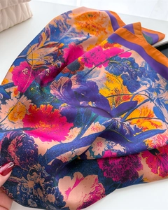 Detailed macro view of a vibrant colorful floral printed imitation silk square scarf