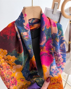 Detailed shot of large silk-like scarf featuring colorful floral and fruit oil painting prints