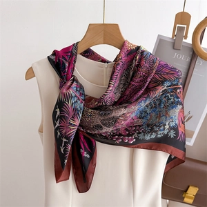 Elegant tropical palm leaf and feather print silk scarf with purple and royal blue tones