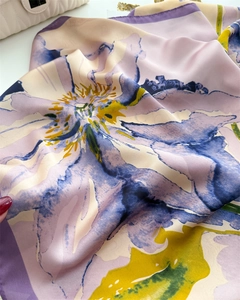 Close-up of elegant floral print silk scarf with lavender and pastel tones texture