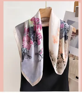 Detail of silk-like neckerchief with floral print draped over a black vest dress