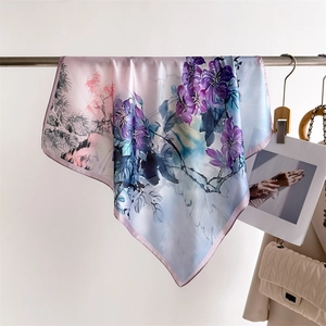 Detail of silk-like square scarf featuring elegant bamboo patterns and floral print