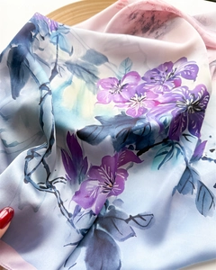 Close-up of floral satin scarf texture with elegant blue and pink ink wash patterns