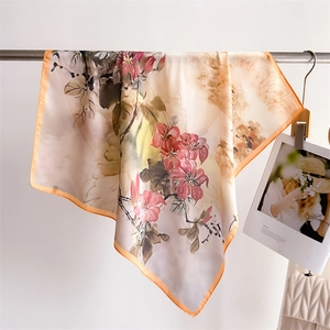 Detail of silk-like floral scarf with ink painting pattern and elegant orange border