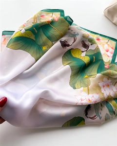 Detailed close-up of lotus flower and koi fish ink print on satin square scarf