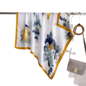 Elegant floral silk square scarf with blue blossoms and yellow borders on white background
