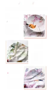 Detailed close-up of floral and bird print on silk-like scarf with fine hemmed edges