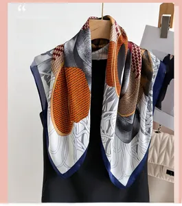 Detail of silk-like geometric pattern scarf draped on a wooden hanger with modern styling