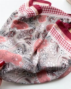 Detailed shot of houndstooth and floral print silk scarf with burgundy border