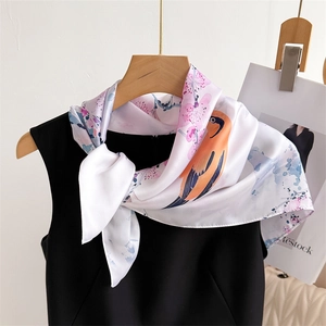 70cm silk-like square scarf featuring floral bird prints tied on an elegant outfit