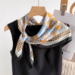 Elegant paisley and houndstooth satin silk scarf worn on a chic black sleeveless top