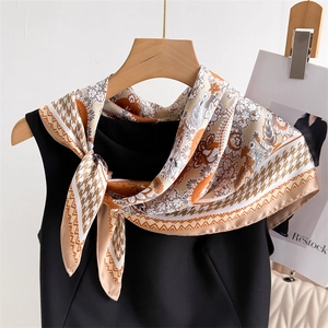 Elegant houndstooth floral silk-like square scarf in earth tones on a wooden hanger