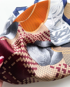 Detail of satin silk scarf with geometric plaid print in burgundy and navy colors