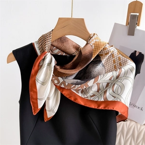 70cm silk-like square scarf featuring warm orange and brown geometric patterns on a hanger