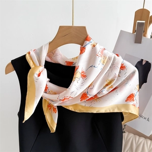 70cm floral print silk-feel square scarf tied on a black dress with yellow border
