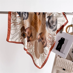 Detailed view of luxury 70cm silk-like scarf with equestrian print and orange edges