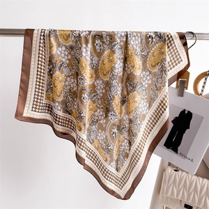 Detail of silk-like satin square scarf featuring paisley and houndstooth patterns