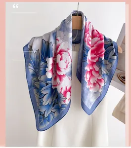 Detailed view of floral silk scarf featuring elegant blue patterns and pink peony prints