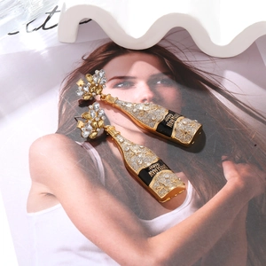 Detail of champagne bottle earrings with rhinestones and Happy New Year text