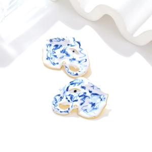 Colorful elephant stud earrings with white enamel and blue marble pattern in gold plating