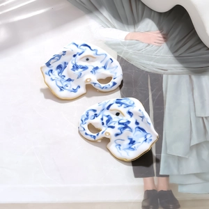 Detail of blue and white marble pattern earrings with elegant gold trim edges