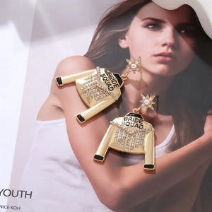 Detail of Bride Squad jacket earrings with rhinestone fringe and pearl star studs