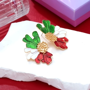 Macro shot of colorful floral earrings with shiny glitter enamel and golden pistil details