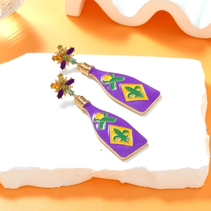 Detail of purple enamel wine bottle earrings with gold Fleur-de-lis and gem flower studs