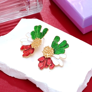 Floral petal earrings with colorful enamel and gold base on a textured stone surface