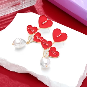 Red heart drop earrings with pearl pendants and I Love You inscription in gold finish