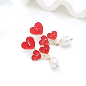 Romantic gold drop earrings with red enamel hearts, white 'I LOVE YOU' text and teardrop pearls