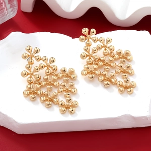 Long gold alloy multilayer flower drop earrings on a minimalist stone pedestal